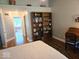 Bright bedroom featuring wood floors, a vaulted ceiling and a built-in bookshelf at 8394 Glen Highlands Dr, Indianapolis, IN 46236