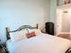 Comfortable bedroom with a wrought iron bed frame, soft lighting, and a cozy atmosphere at 8394 Glen Highlands Dr, Indianapolis, IN 46236