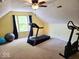 Bright bonus room with vaulted ceiling, carpet, and home gym equipment at 8394 Glen Highlands Dr, Indianapolis, IN 46236