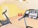 Carpeted bonus room features fitness equipment, including an elliptical and treadmill, plus charming decorative rocking chairs at 8394 Glen Highlands Dr, Indianapolis, IN 46236