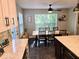 Bright dining area adjacent to the kitchen featuring a long wooden table and ample natural light at 8394 Glen Highlands Dr, Indianapolis, IN 46236