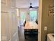 Charming dining area with a large wood table and backyard access at 8394 Glen Highlands Dr, Indianapolis, IN 46236