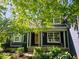 Welcoming exterior with a quaint front porch and lush landscaping at 8394 Glen Highlands Dr, Indianapolis, IN 46236