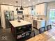 Bright kitchen features white cabinets, stainless steel appliances, and a large island with breakfast bar at 8394 Glen Highlands Dr, Indianapolis, IN 46236