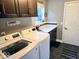 Functional laundry room featuring a washer, dryer, storage, and a door to the outside at 8394 Glen Highlands Dr, Indianapolis, IN 46236