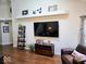Bright living room with a mounted TV, hardwood floors, and minimalist decor for a modern feel at 8394 Glen Highlands Dr, Indianapolis, IN 46236