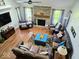 Cozy living room featuring a brick fireplace, hardwood floors, and ample natural light from large windows at 8394 Glen Highlands Dr, Indianapolis, IN 46236
