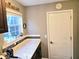 Functional mudroom area with a window, white door, and neutral wall color at 8394 Glen Highlands Dr, Indianapolis, IN 46236
