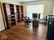 Home office features hardwood floors, bright window, a computer desk, and dark wood shelving at 8394 Glen Highlands Dr, Indianapolis, IN 46236
