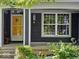 Inviting porch with yellow door, plants and charming decor at 8394 Glen Highlands Dr, Indianapolis, IN 46236