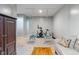 Finished basement with a couch, hanging chairs, exercise bike and a wood storage unit at 8754 Lily Ct, Zionsville, IN 46077