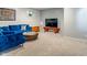 Bright and inviting basement featuring a comfortable blue sofa and modern decor at 8754 Lily Ct, Zionsville, IN 46077