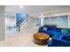 Large finished basement showcasing a staircase, recreational games, and comfortable furnishings at 8754 Lily Ct, Zionsville, IN 46077