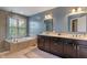 This primary bathroom boasts double sinks, a soaking tub, and a glass enclosed shower at 8754 Lily Ct, Zionsville, IN 46077