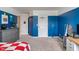 Bright bedroom with blue walls, neutral carpet, and built-in basketball hoop perfect for a room at 8754 Lily Ct, Zionsville, IN 46077