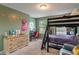Charming bedroom with bunk beds, cozy armchair, desk, and dresser with fun decor accents at 8754 Lily Ct, Zionsville, IN 46077