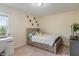 A cozy bedroom features a bed with storage drawers, a desk by the window, and neutral decor at 8754 Lily Ct, Zionsville, IN 46077