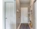 Entryway with gray walls, a coat closet, and storage shelves with a bench at 8754 Lily Ct, Zionsville, IN 46077