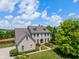 Aerial view of a two-story brick house featuring manicured landscaping and a circular driveway at 8754 Lily Ct, Zionsville, IN 46077