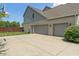 Side view of home featuring an attached two-car garage and neutral brick and siding at 8754 Lily Ct, Zionsville, IN 46077