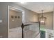 Upstairs hallway features wood railing and an open view of the entryway with modern lighting at 8754 Lily Ct, Zionsville, IN 46077