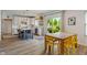 Modern kitchen with an island, dining area, and sliding glass doors at 8754 Lily Ct, Zionsville, IN 46077