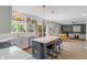 Open concept kitchen features an eat-in island, stainless appliances, and bright natural light at 8754 Lily Ct, Zionsville, IN 46077