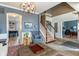 Cozy living room with an open staircase, wood floors, and modern furnishings at 8754 Lily Ct, Zionsville, IN 46077