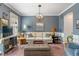 Comfortable living room featuring neutral sofa, stylish decor and a large window at 8754 Lily Ct, Zionsville, IN 46077