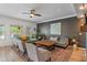Open living room with neutral colored couches, plants, and a ceiling fan at 8754 Lily Ct, Zionsville, IN 46077