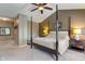This spacious main bedroom features a ceiling fan, large windows, and a four-poster bed at 8754 Lily Ct, Zionsville, IN 46077