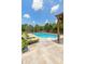 Inviting rectangular pool with modern lounge chairs and a pergola surrounded by a lush backyard at 8754 Lily Ct, Zionsville, IN 46077