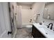 Clean bathroom features a shower-tub combo, dark vanity, and updated fixtures at 9323 Doubloon Rd, Indianapolis, IN 46268