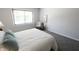 Serene bedroom featuring a queen bed, large window, and minimalist decor at 9323 Doubloon Rd, Indianapolis, IN 46268