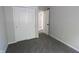 Clean bedroom with neutral walls, plush carpet and closet with bi-fold doors at 9323 Doubloon Rd, Indianapolis, IN 46268