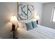 Inviting bedroom features a queen bed, modern artwork, and bedside lamps for a relaxing ambiance at 9323 Doubloon Rd, Indianapolis, IN 46268
