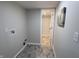 Hallway with laundry hookups leading to a bright bathroom at 9323 Doubloon Rd, Indianapolis, IN 46268