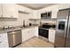 Beautiful kitchen with white cabinets, stainless steel appliances, and granite countertops at 9323 Doubloon Rd, Indianapolis, IN 46268