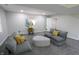 Living room with ample seating, carpet, and a view into another room at 9323 Doubloon Rd, Indianapolis, IN 46268