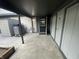 Backyard covered patio with a black entry door and storage at 9458 Fordham St, Indianapolis, IN 46268