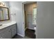 Bathroom with a modern vanity, wood-framed mirror, and an adjacent toilet and shower at 9458 Fordham St, Indianapolis, IN 46268