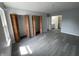 This bedroom features sleek gray floors and a large closet with louvered folding doors at 9458 Fordham St, Indianapolis, IN 46268
