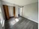 Bedroom featuring modern gray floors and a closet with folding louvered doors at 9458 Fordham St, Indianapolis, IN 46268