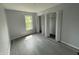 Bedroom featuring modern gray floors and a closet with white folding louvered doors at 9458 Fordham St, Indianapolis, IN 46268