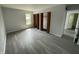 Spacious bedroom featuring modern gray flooring and closet with folding louvered doors at 9458 Fordham St, Indianapolis, IN 46268