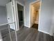 Hallway with wood floors leading to a bathroom and bedroom, showcasing the layout at 9458 Fordham St, Indianapolis, IN 46268