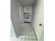 Hallway view into the kitchen featuring white cabinets, tile floors and a marble countertop at 9458 Fordham St, Indianapolis, IN 46268