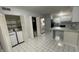 Open kitchen area with a small breakfast bar, appliances, and tile flooring at 9458 Fordham St, Indianapolis, IN 46268
