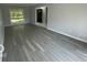 Inviting living room with wood floors, large window, and neutral paint scheme, ideal for relaxation at 9458 Fordham St, Indianapolis, IN 46268
