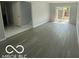 Spacious living room featuring modern wood floors and a sliding glass door for natural light at 9458 Fordham St, Indianapolis, IN 46268